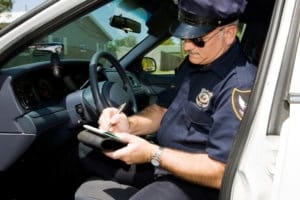 Police - Time for a Ticket Police officer in his squad car, filling out a citation.